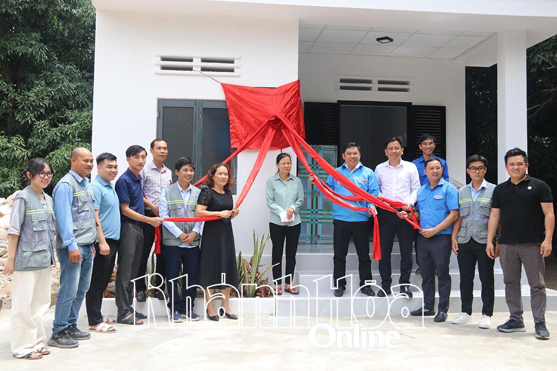 Các đại biểu thực hiện kéo băng khánh thành và trao tặng Nhà nhân ái cho gia đình bà Huỳnh Thị Hải.
